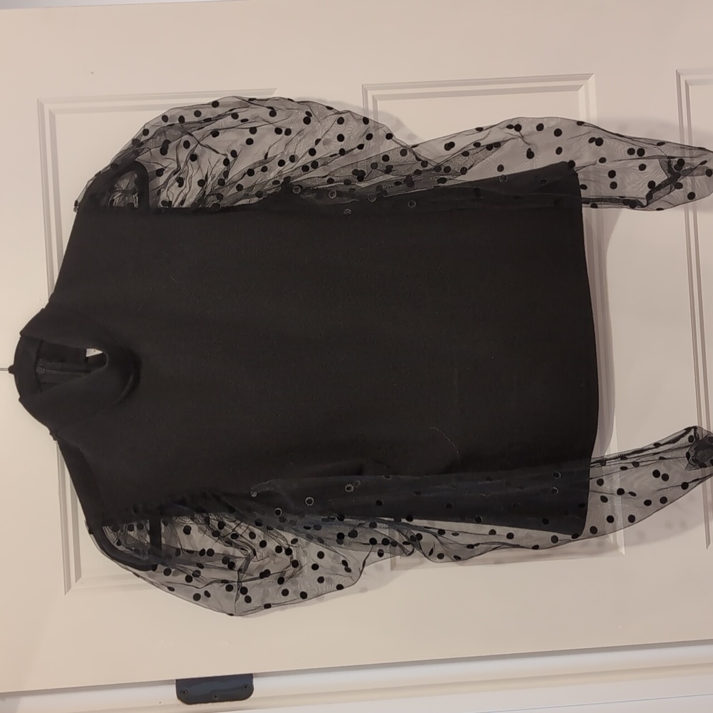 Black crepe knit turtle neck with sheer long sleeve, puff shoulder